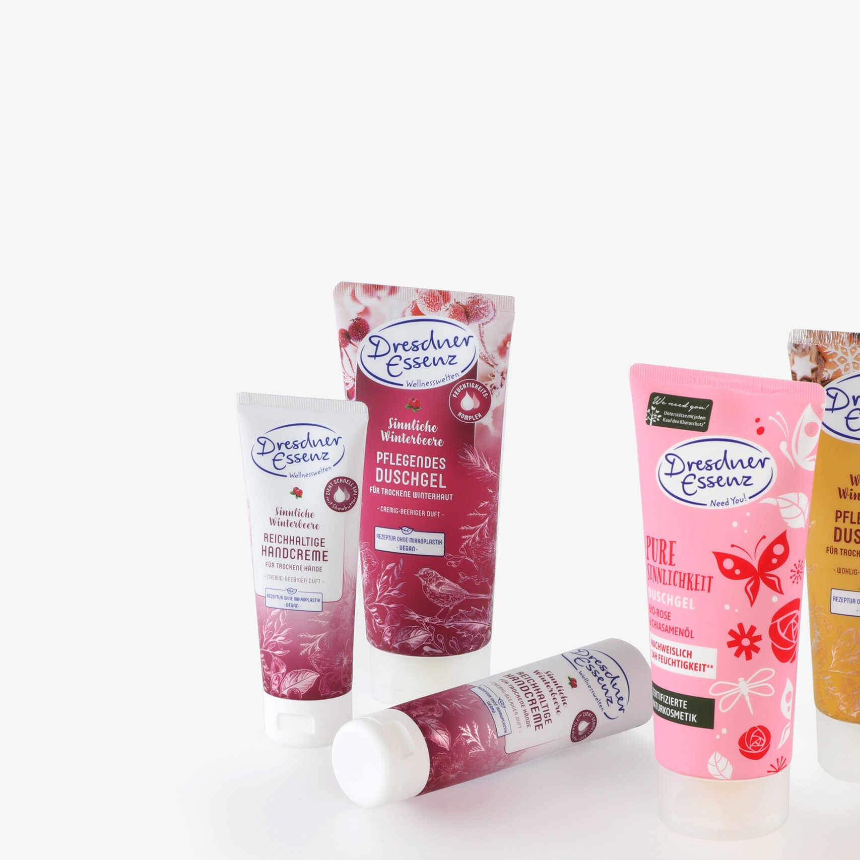 Groupe de cinq tubes de produits de soins corporels de la marque Dresdner Essenz, imprimés différemment.